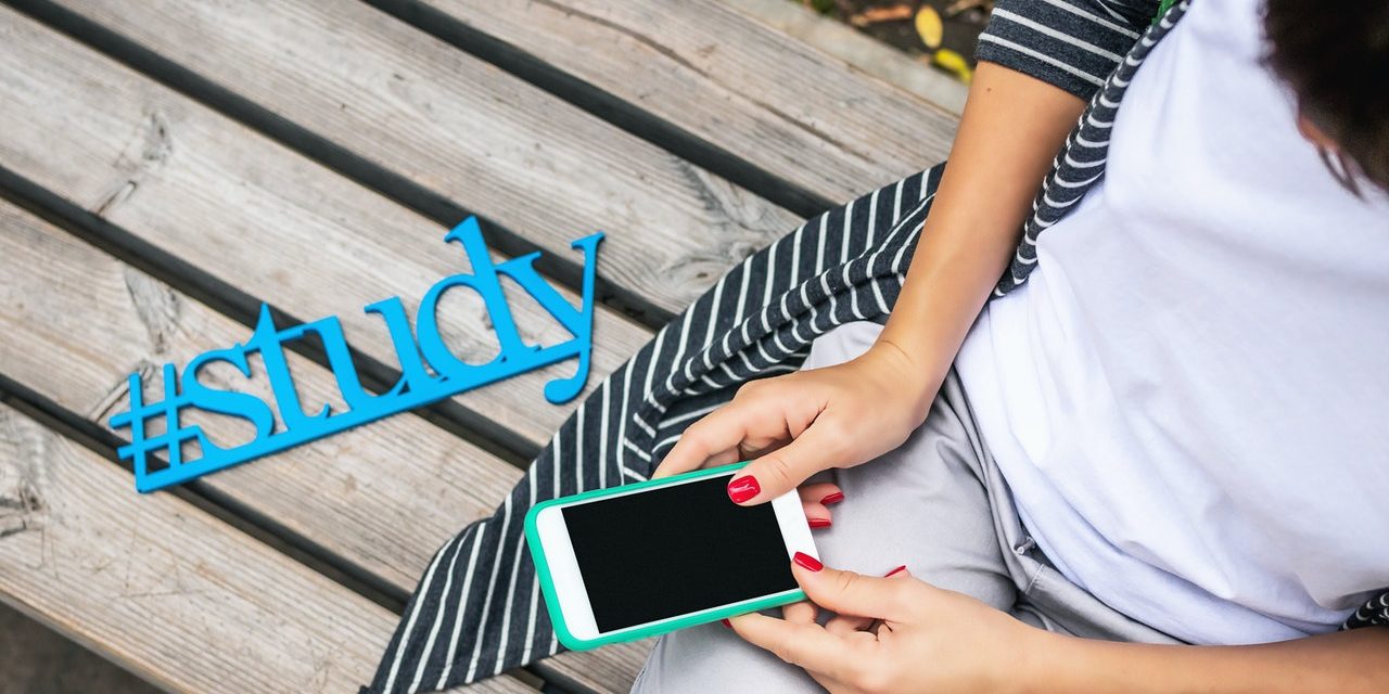 person-sits-on-bench-holding-phone-2679350