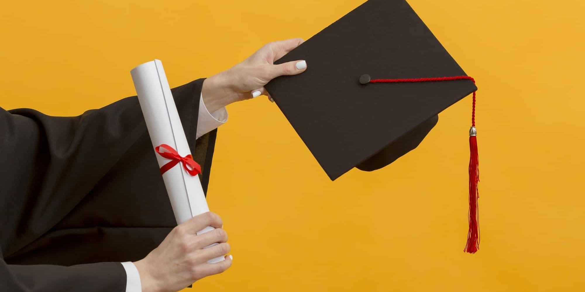 close-up-hands-holding-diploma-cap