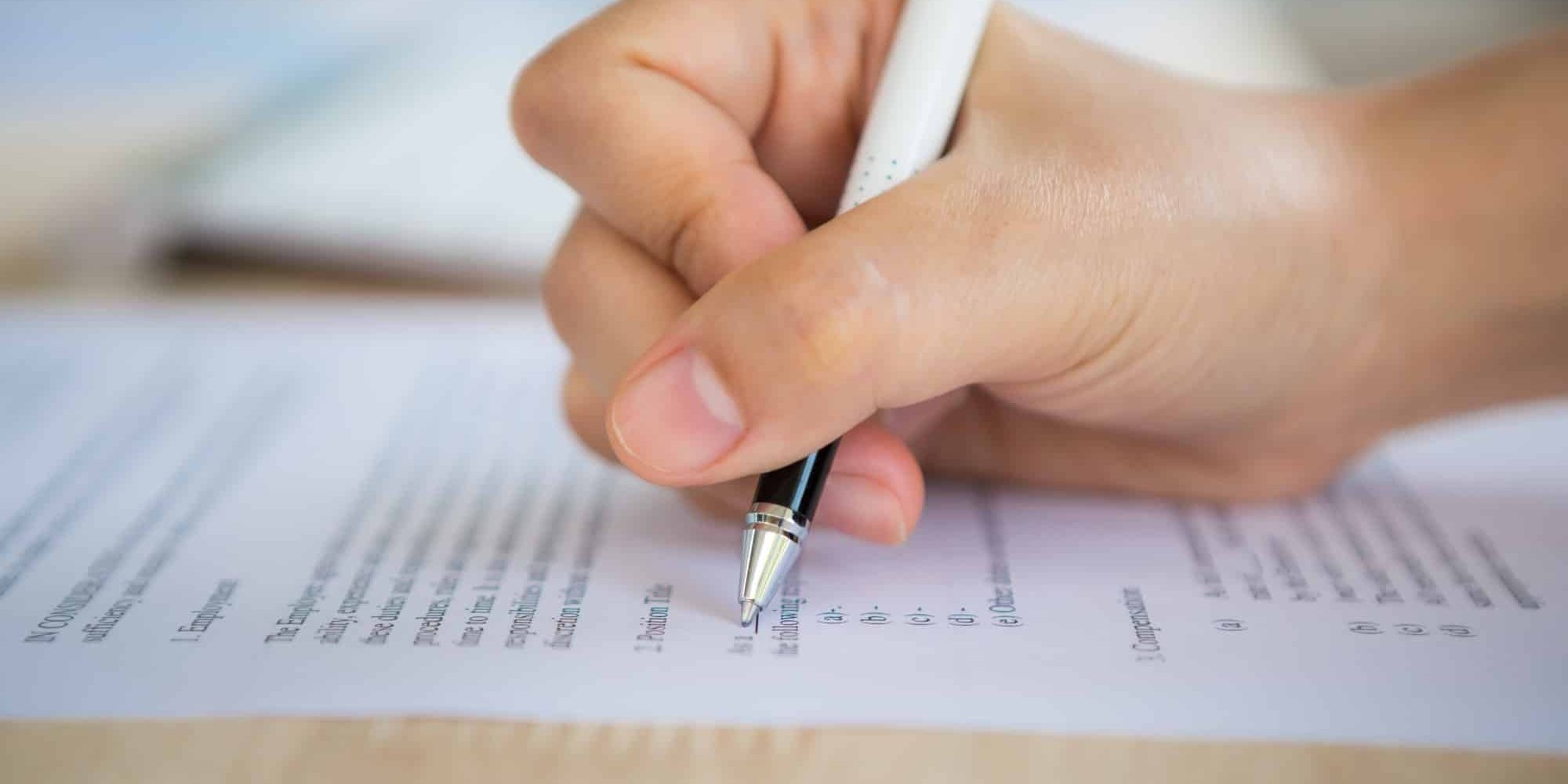 hand-with-pen-writing-paper